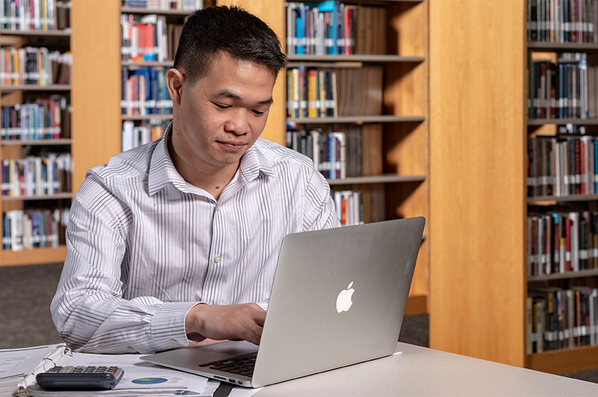 Student working on computer in the library