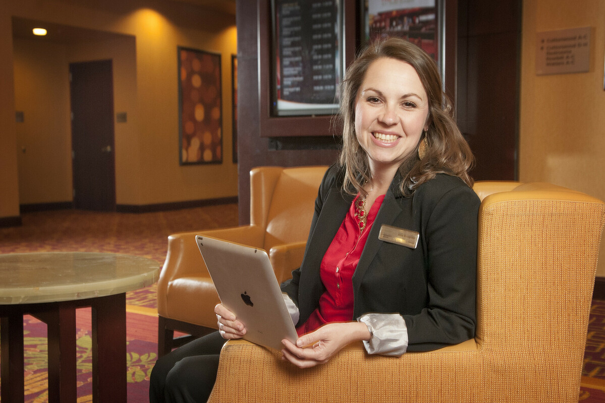 Female professional holding her ipad and smiling