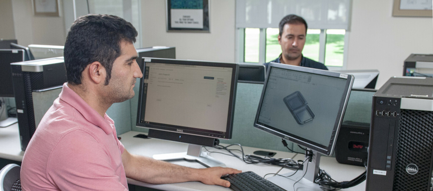 Male student sitting in front of the computer working