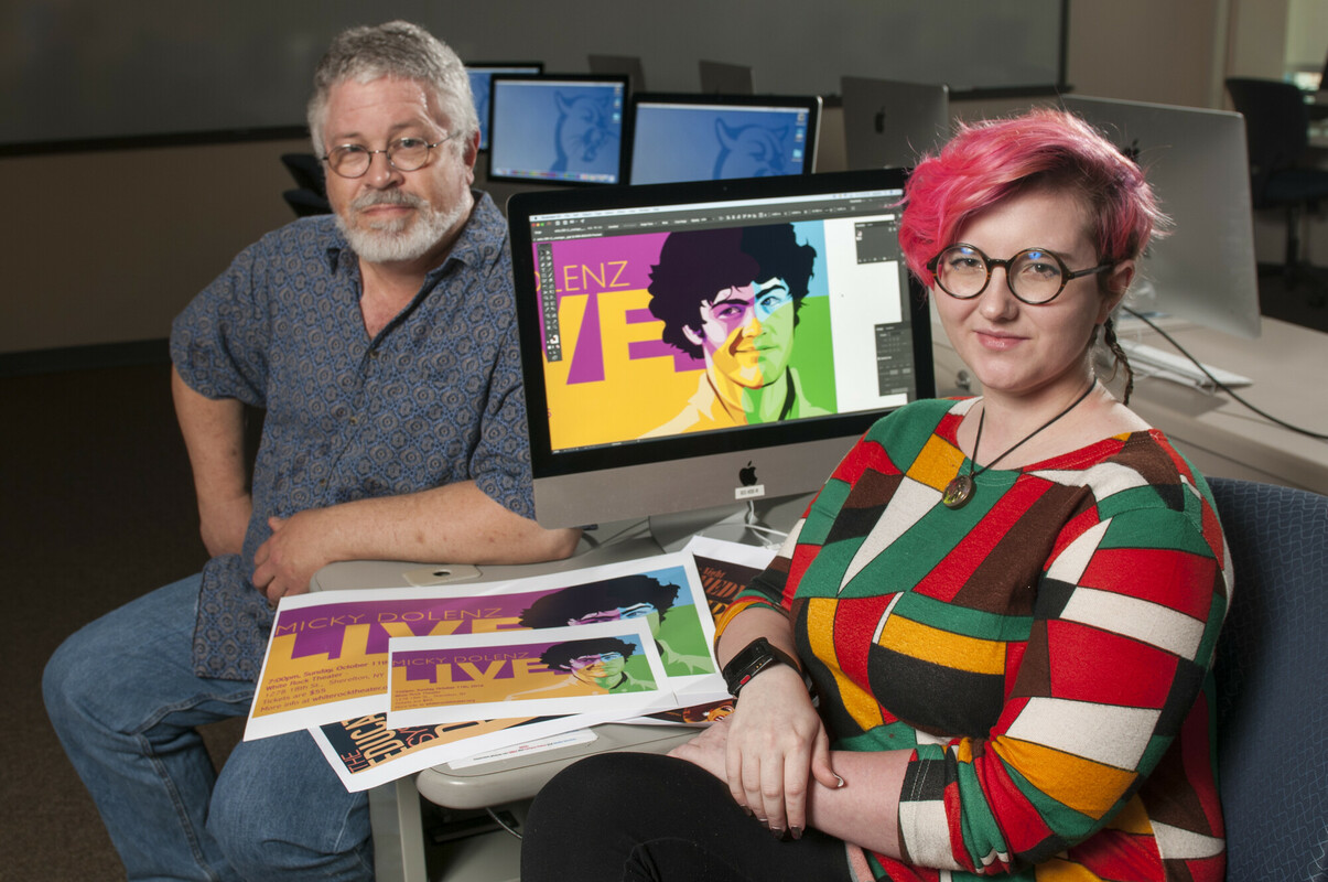 Student and instructor showing their graphic design works