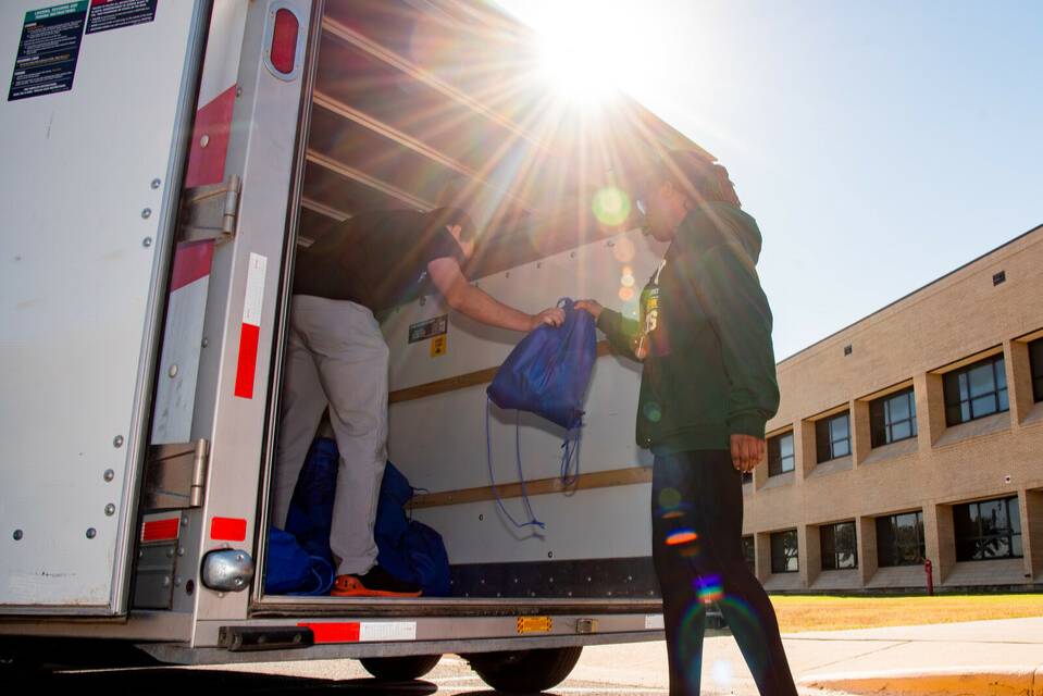 People unloading stuff from a truck