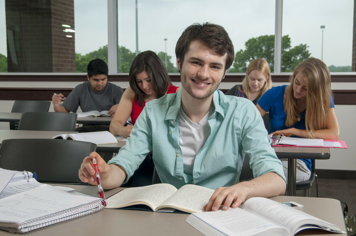 Student sitting the classroom and smiling