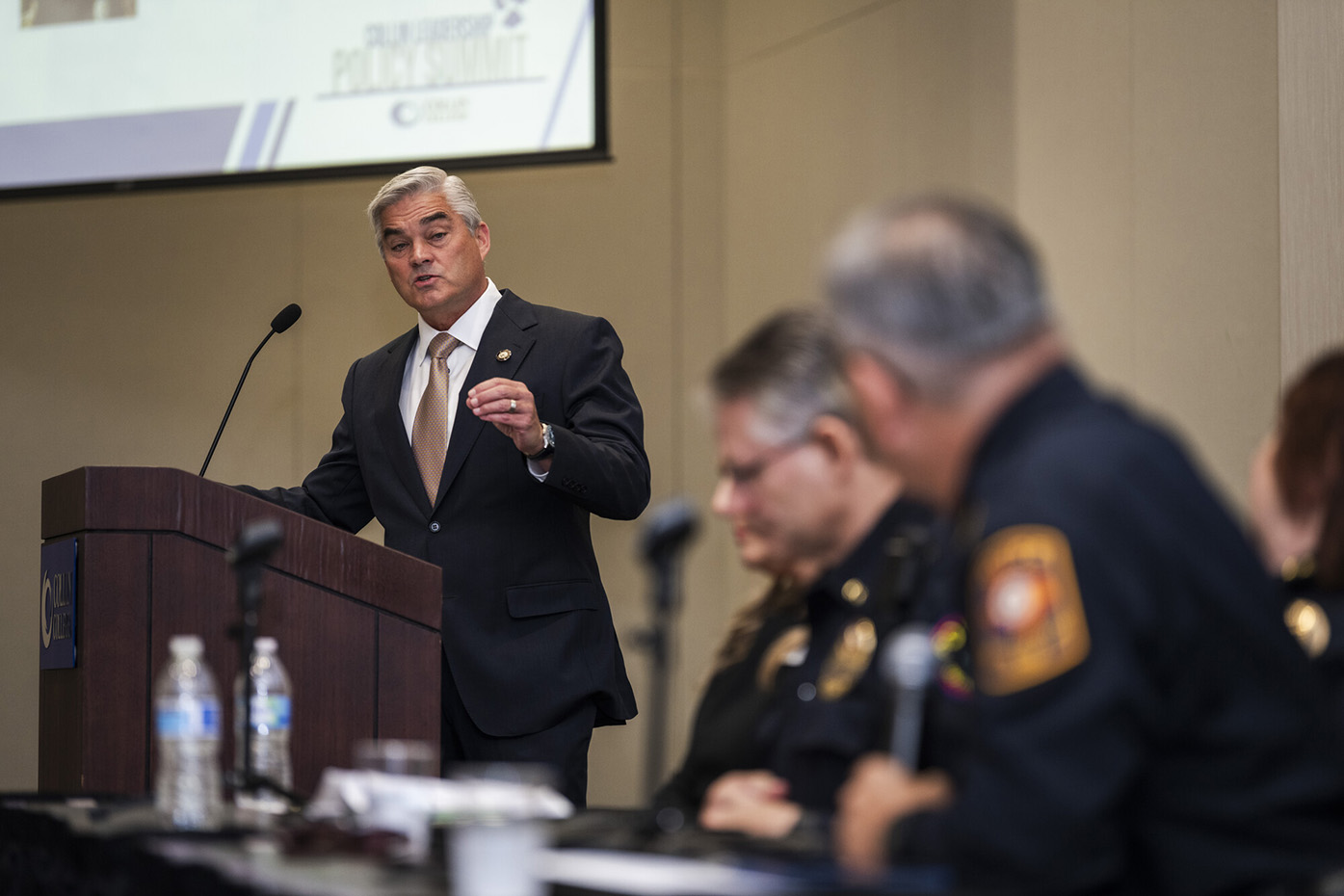 David Bristol, mayor of Prosper, acts as moderator for the Campus Safety & Security panel as panel members look on. 