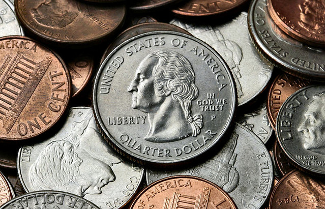 Stock image of a pile of coins, including quarters, pennies, nickels, and dimes. 