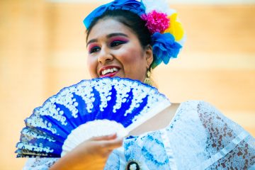 A dancer dressed in a traditional outfit performing at a Hispanic Heritage Month event.